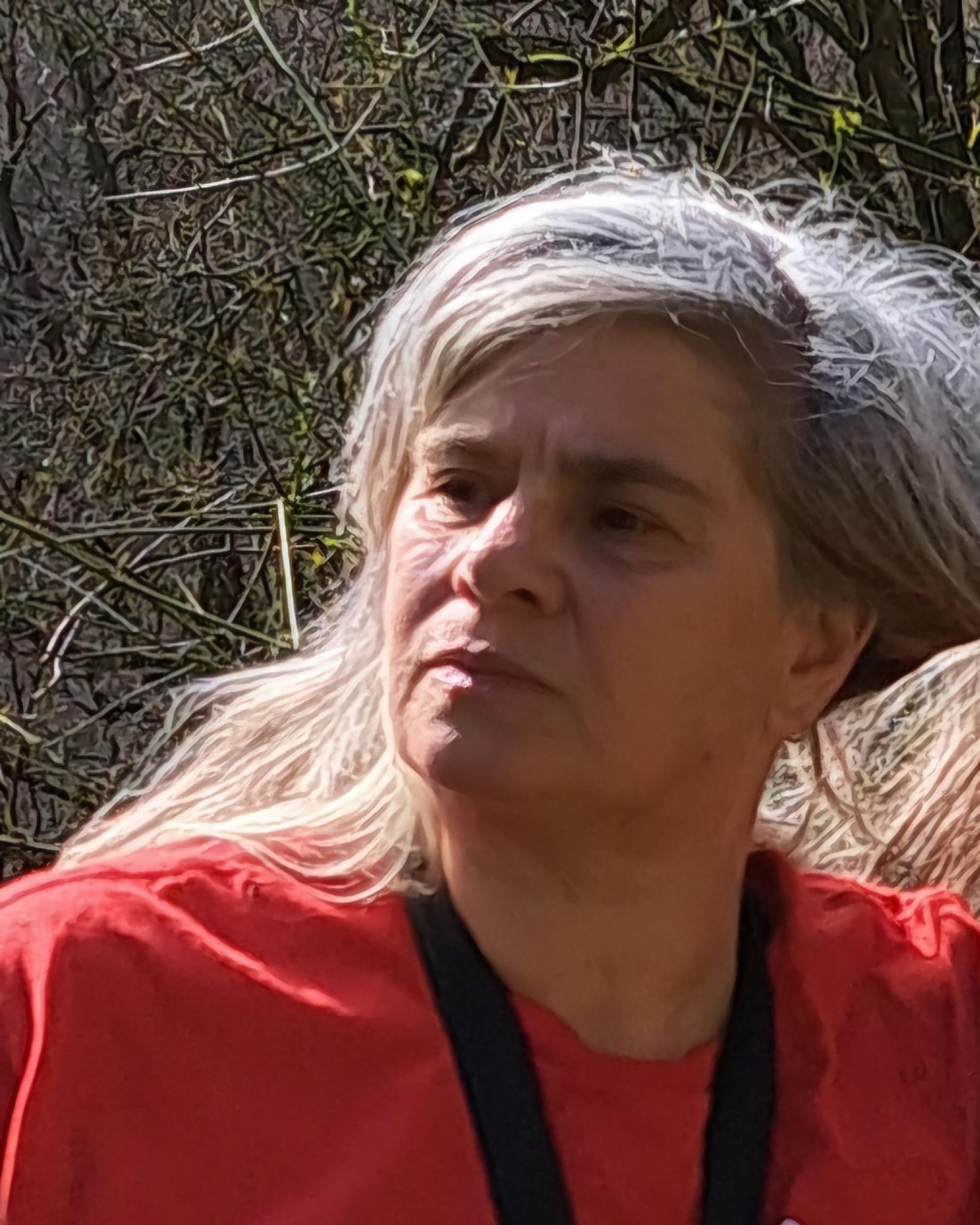 Photograph of Chris who is wearing a red top