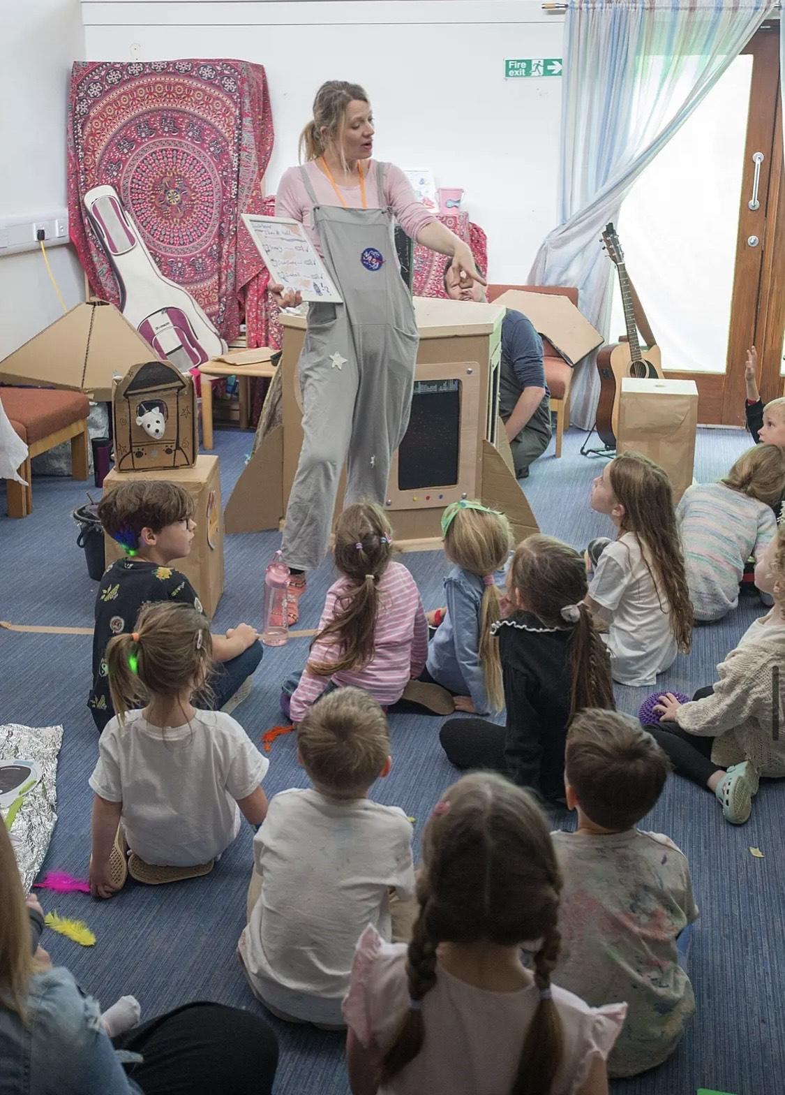 A photograph of Monika talking to young people.