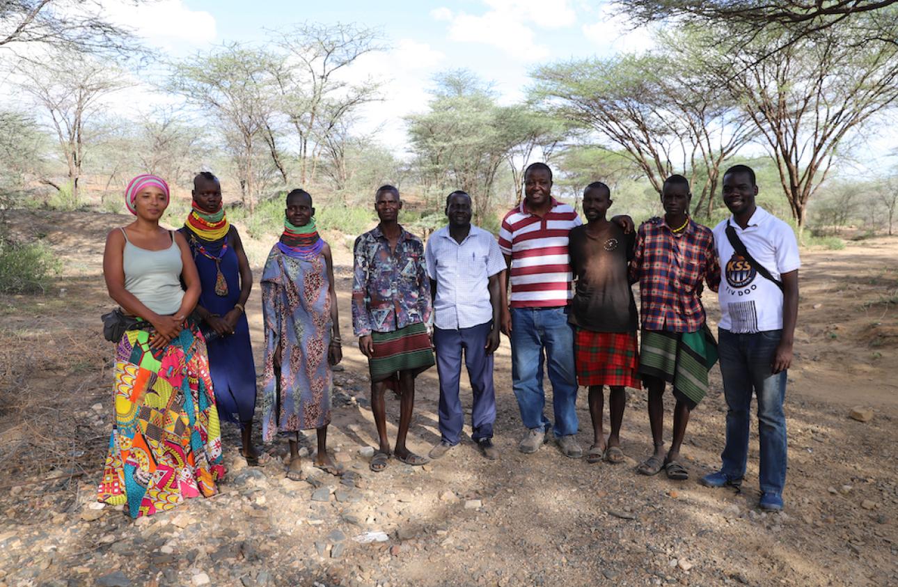 Storytellers Mara Menzies (left) and John Namai (right) pose for a photo after an interview with youth in Loima, Turkana County, Kenya. In the middle are local chief and ICPAC User Engagement Expert Calistus Wachana (in striped t-shirt).