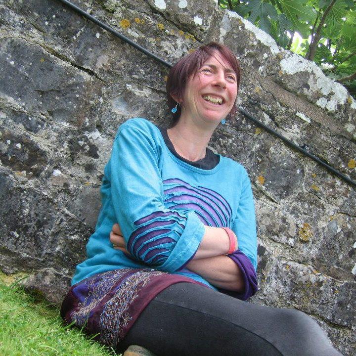 Photo of Rachel sat next to a wall