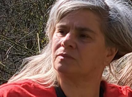 Photograph of Chris who is wearing a red top