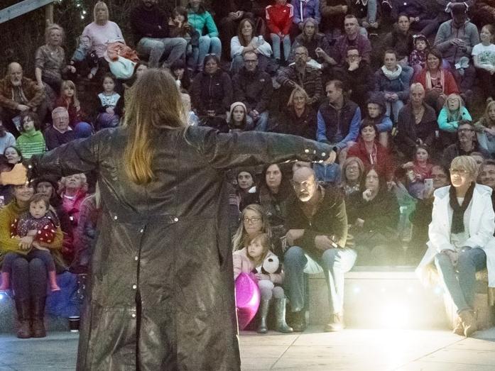 A storyteller performing in front of an audience.