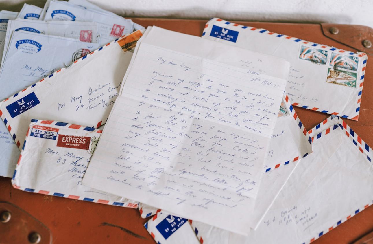 a photograph showing a pile of letters and air mail envelopes