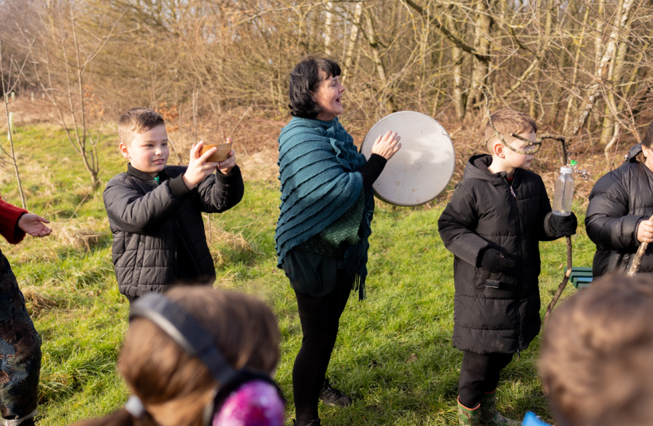 Ann Jones playing an instrument with a group of children